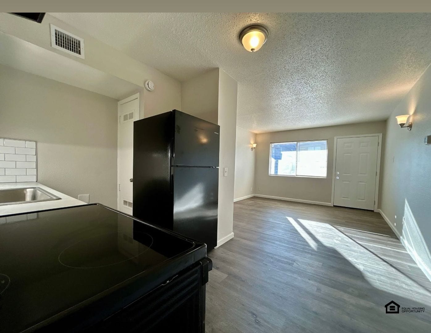 Kitchen with black appliances, unfurnished at The Jackson
