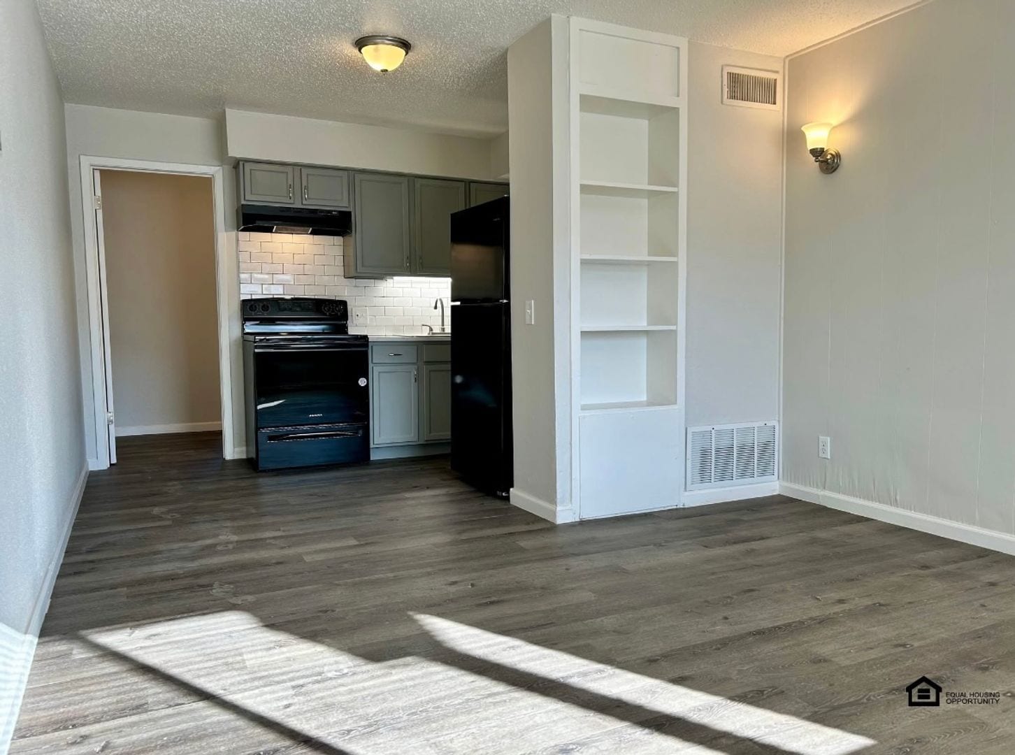 Open living area and kitchen, unfurnished at The Jackson