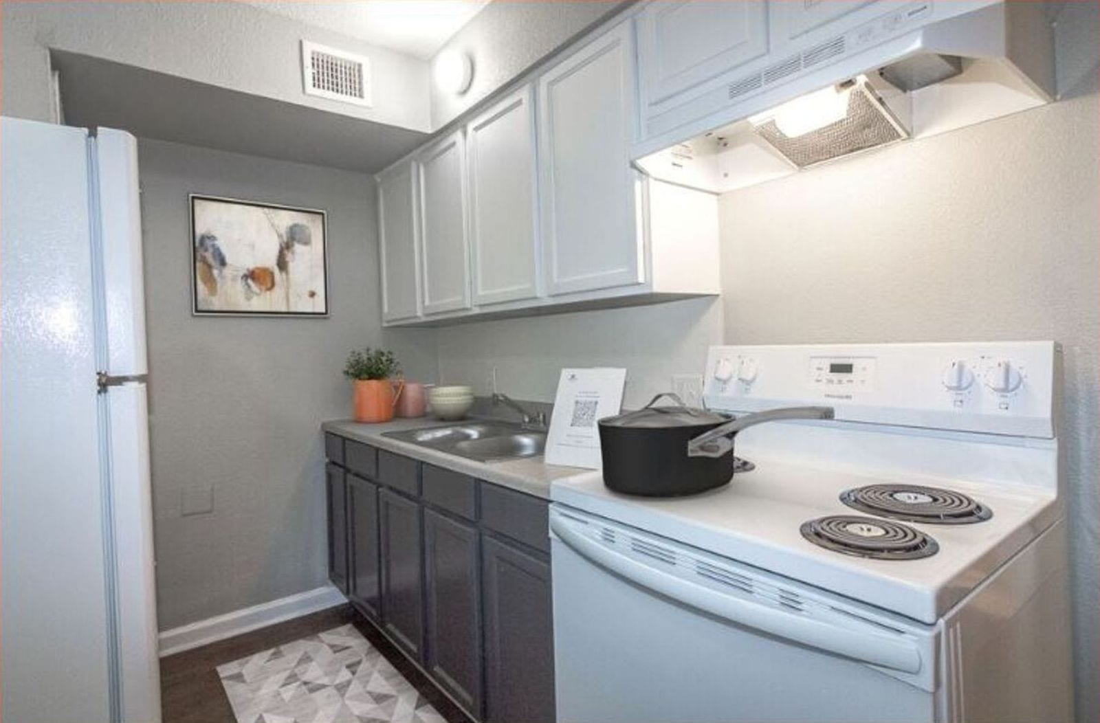 Galley kitchen with new range, virtually staged at The Jackson
